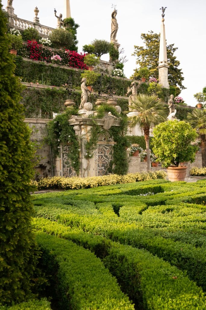 Italian garden in Stresa, Italy featuring lush greenery and classical sculptures.